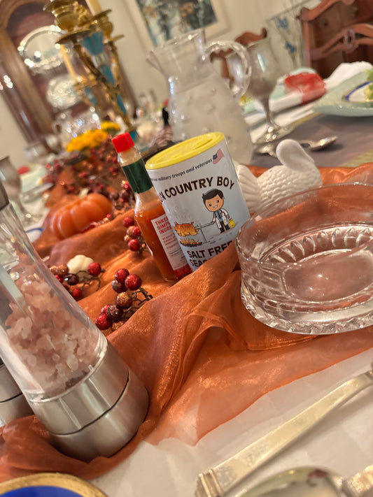 Cajun Country Boy Salt-Free Seasoning can on an autumn dining table.